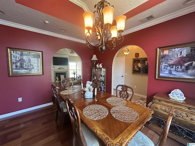5050 Lily Rd, Hokes Bluff, AL 35903 - dining area with arched walkways, baseboards, visible vents, wood finished floors, and ornamental molding