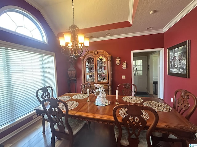 5050 Lily Rd, Hokes Bluff, AL 35903 - dining space featuring lofted ceiling, wood finished floors, an inviting chandelier, and ornamental molding