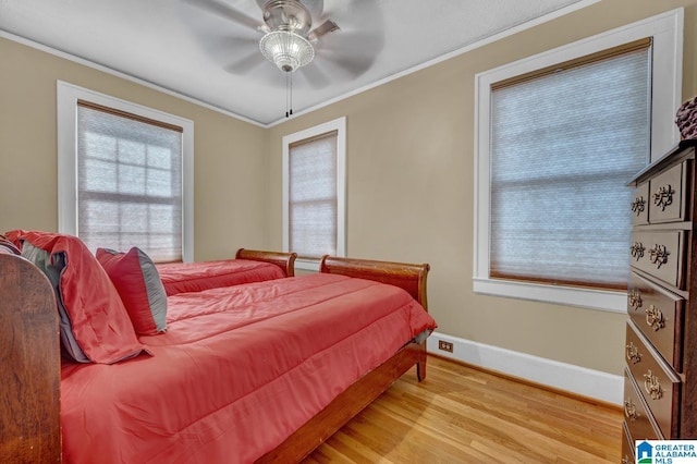 2910 W Meighan Blvd, Gadsden, AL 35904 - bedroom featuring multiple windows, wood finished floors, baseboards, and ornamental molding