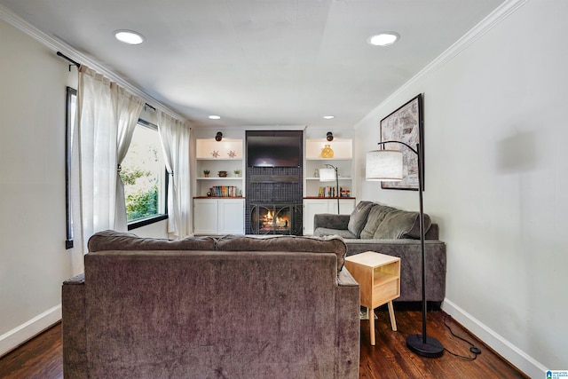 living area featuring crown molding, baseboards, dark wood-type flooring, and a fireplace
