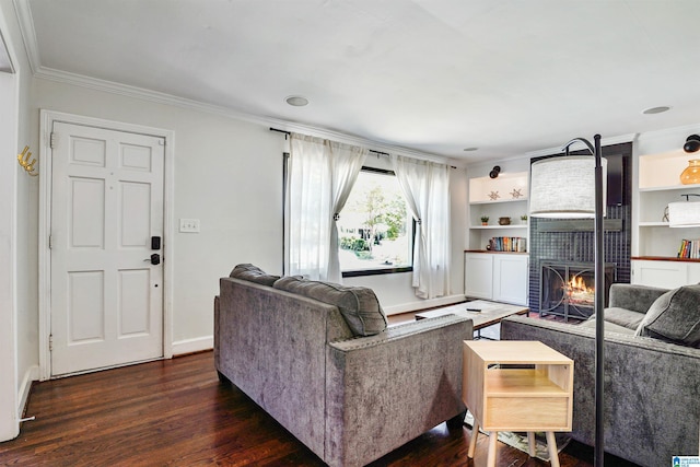 living room with a brick fireplace, baseboards, dark wood finished floors, and ornamental molding