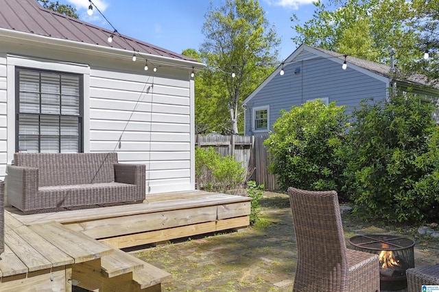 exterior space with fence and a fire pit