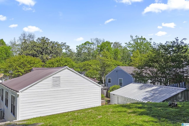 view of home's exterior with central air condition unit and a lawn