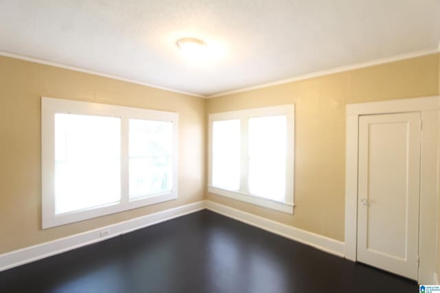 spare room featuring baseboards and ornamental molding