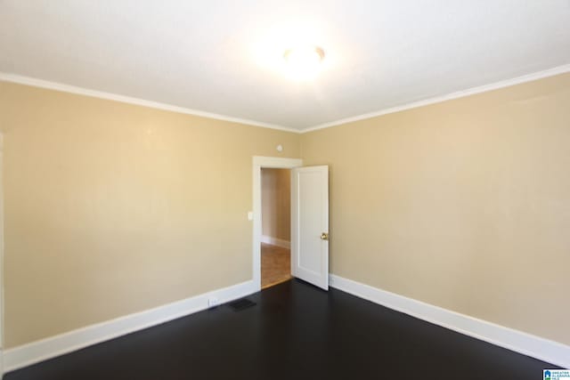 spare room featuring baseboards and crown molding