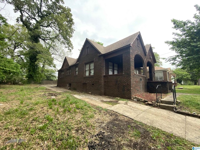 view of side of home with brick siding