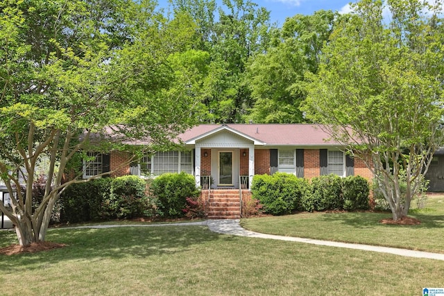 ranch-style house with brick siding and a front lawn