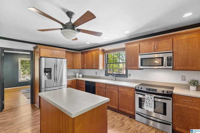 kitchen with light countertops, ornamental molding, stainless steel appliances, and a sink