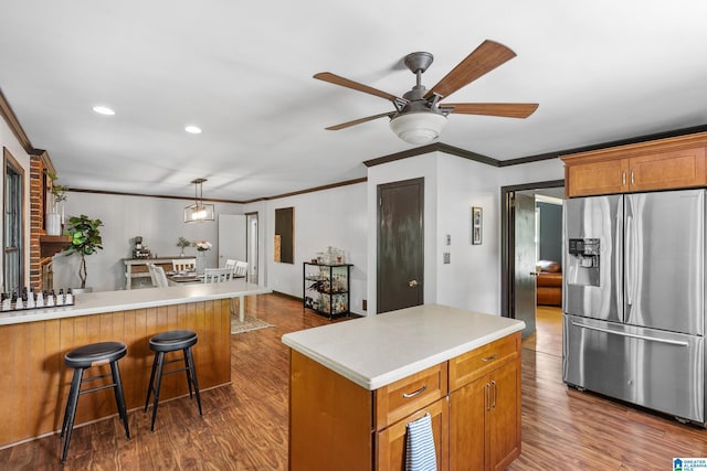 kitchen featuring ceiling fan, stainless steel refrigerator with ice dispenser, crown molding, and dark wood-style flooring
