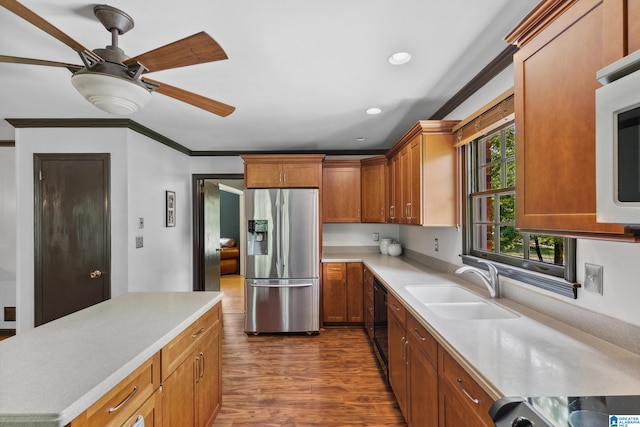 kitchen with a sink, ceiling fan, stainless steel appliances, light countertops, and dark wood finished floors