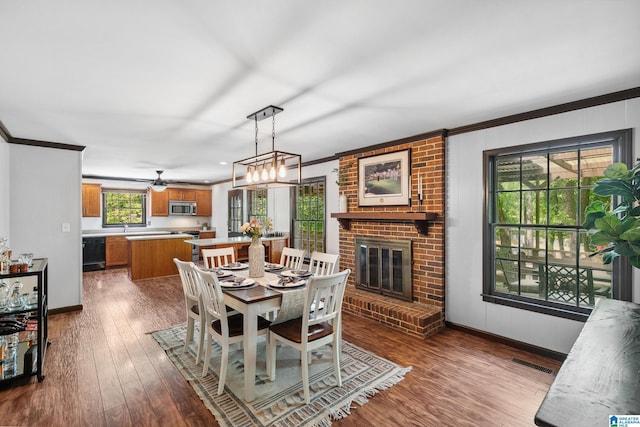 dining room featuring baseboards, ornamental molding, dark wood-type flooring, and visible vents