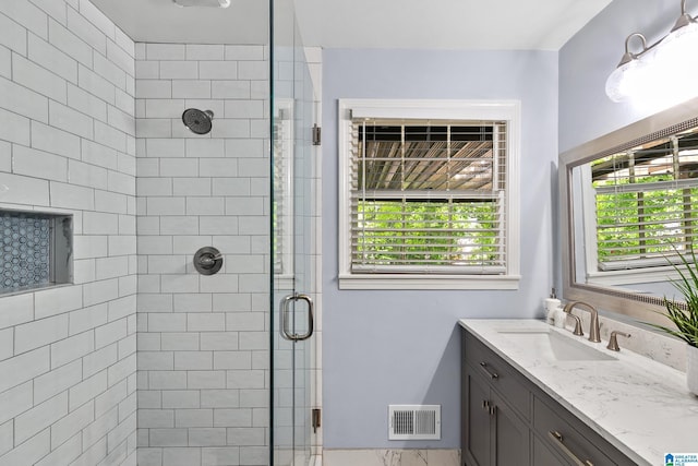 full bathroom with a shower stall, vanity, and visible vents