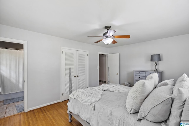 bedroom featuring baseboards, a ceiling fan, and wood finished floors