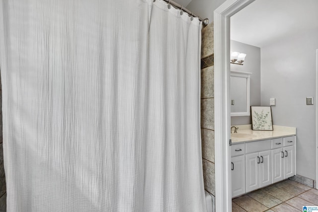 bathroom with tile patterned flooring, a shower with curtain, and vanity