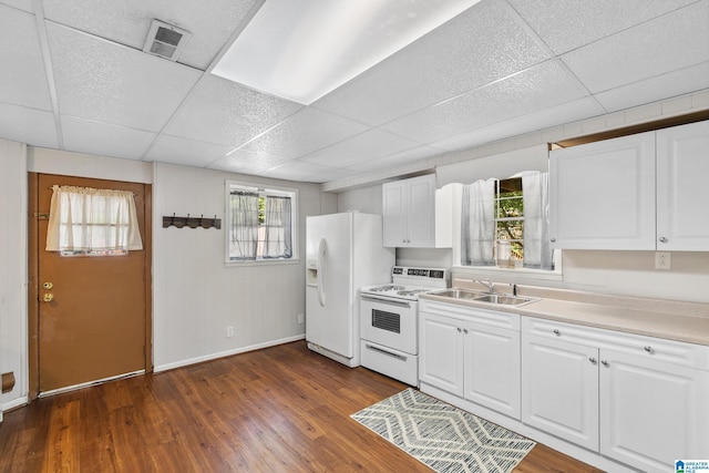 kitchen with visible vents, a paneled ceiling, white appliances, and dark wood finished floors