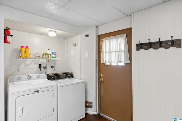 washroom with dark wood finished floors, washing machine and clothes dryer, and laundry area