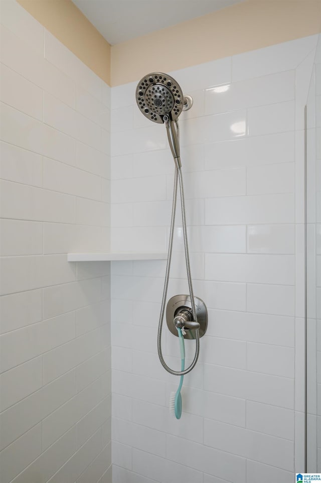 interior details featuring tiled shower