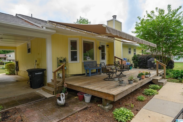 back of property featuring a deck and a chimney