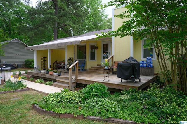 back of house featuring a deck