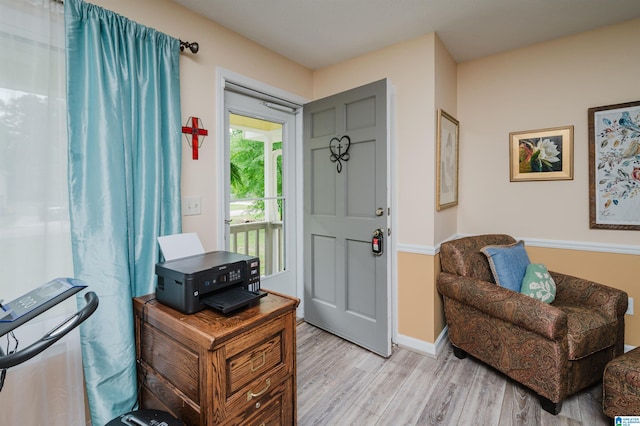 entryway with baseboards and light wood-style floors