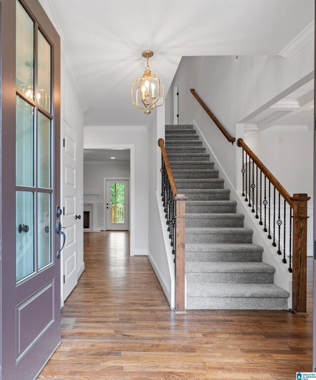 2698 Piedmont Dr, Helena, AL 35022 - foyer entrance featuring crown molding, stairway, a chandelier, light wood-style floors, and baseboards