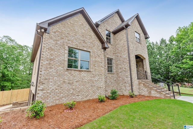 2698 Piedmont Dr, Helena, AL 35022 - view of front of home with stairway, brick siding, fence, and a front yard