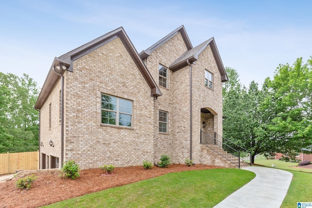 2698 Piedmont Dr, Helena, AL 35022 - view of front facade with a front lawn, an attached garage, brick siding, and fence