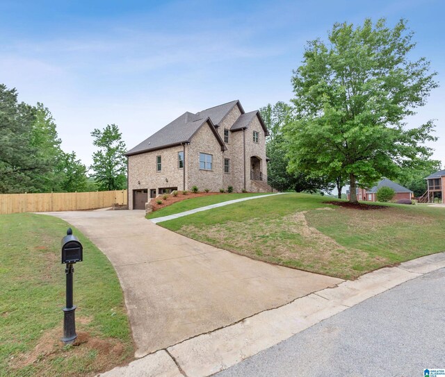 2698 Piedmont Dr, Helena, AL 35022 - french country inspired facade featuring brick siding, fence, a front lawn, concrete driveway, and an attached garage
