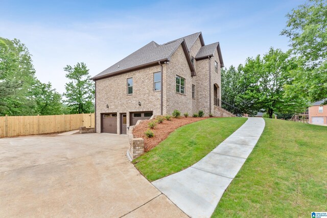 2698 Piedmont Dr, Helena, AL 35022 - view of side of home featuring concrete driveway, fence, a yard, brick siding, and a garage