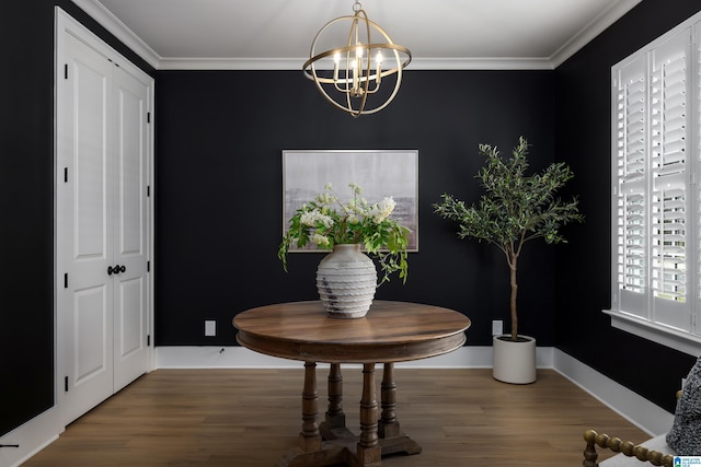 dining space with wood finished floors, a notable chandelier, and ornamental molding