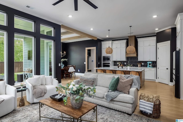 living room featuring recessed lighting, light wood-type flooring, crown molding, visible vents, and ceiling fan with notable chandelier