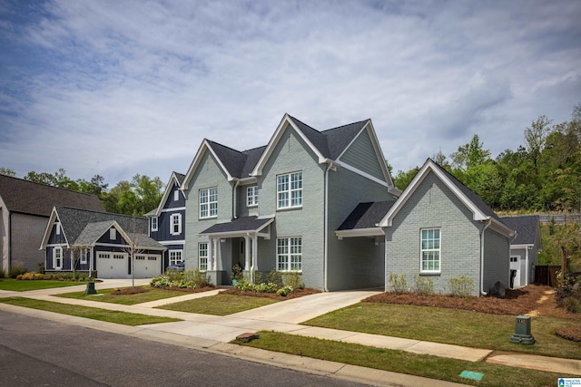 view of front of property with concrete driveway, a front yard, a residential view, and brick siding