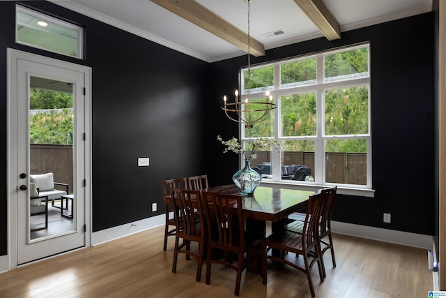 dining space with visible vents, a wealth of natural light, beam ceiling, and a chandelier
