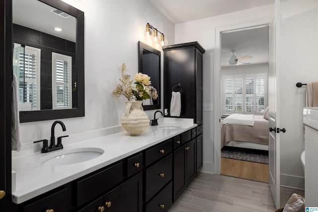bathroom featuring double vanity, visible vents, ensuite bath, and a sink