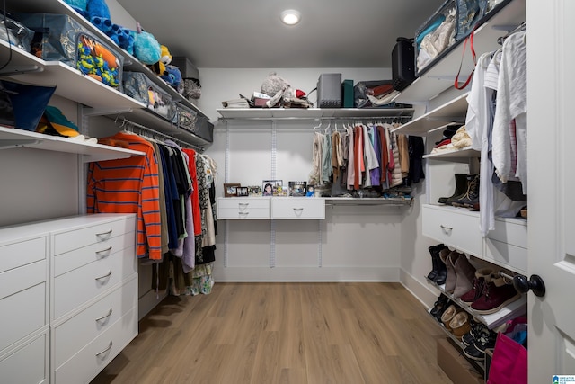 walk in closet featuring light wood finished floors