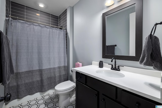 full bath with toilet, tile patterned flooring, shower / tub combo, and vanity