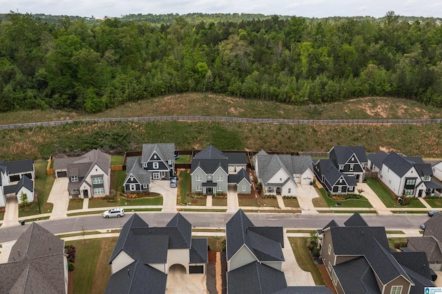 birds eye view of property featuring a wooded view and a residential view