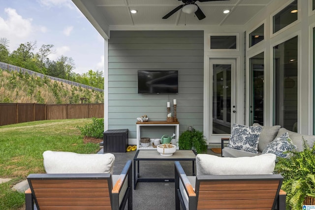 view of patio with an outdoor hangout area, ceiling fan, and fence