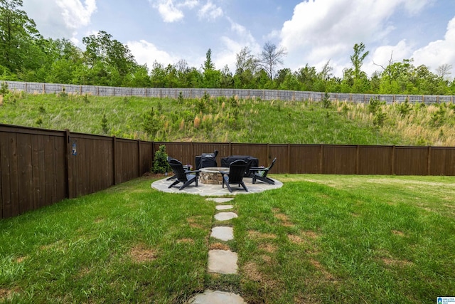 view of yard featuring fence, an outdoor fire pit, and a patio area
