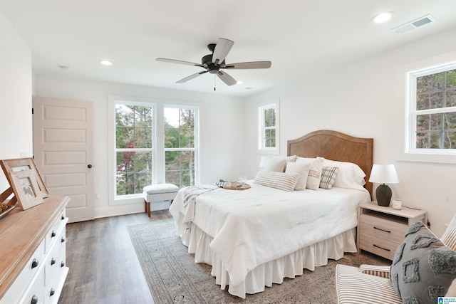 bedroom featuring ceiling fan, wood finished floors, visible vents, and recessed lighting