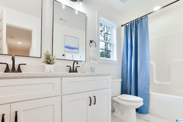 full bath featuring a sink, double vanity, toilet, visible vents, and marble finish floor