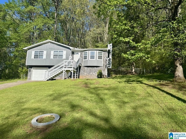 5835 Brenda Dr, Trussville, AL 35173 - view of front of house featuring a front lawn, driveway, stairway, and a garage