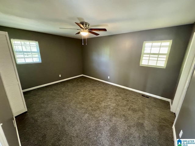 5835 Brenda Dr, Trussville, AL 35173 - unfurnished bedroom with dark colored carpet, a ceiling fan, baseboards, and multiple windows