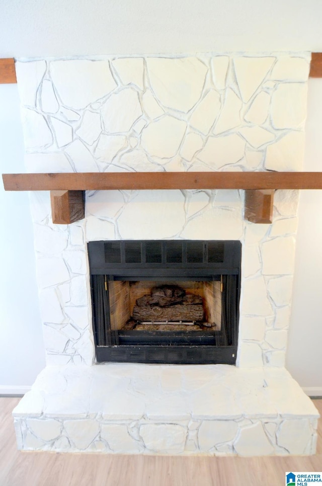 room details with baseboards and a fireplace
