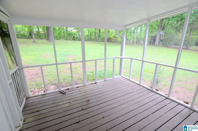 wooden terrace with a fenced backyard and a lawn