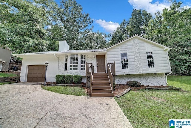 view of front of home with a garage, a front yard, a chimney, metal roof, and driveway