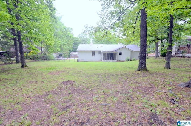 view of yard featuring fence and a sunroom