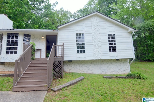 rear view of property with a yard and crawl space