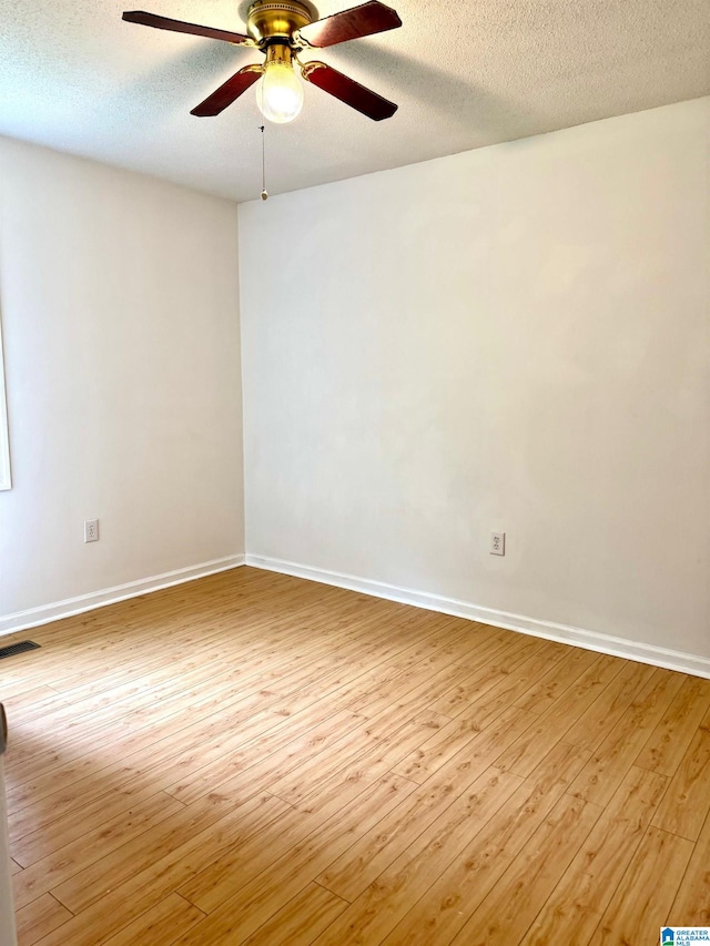 1474 Champion Rd, Oneonta, AL 35121 - empty room featuring wood finished floors, visible vents, baseboards, a textured ceiling, and ceiling fan