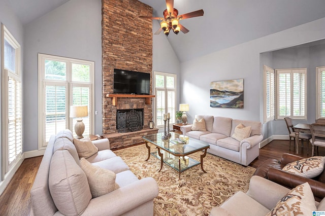 living area with high vaulted ceiling, wood finished floors, a healthy amount of sunlight, and ceiling fan